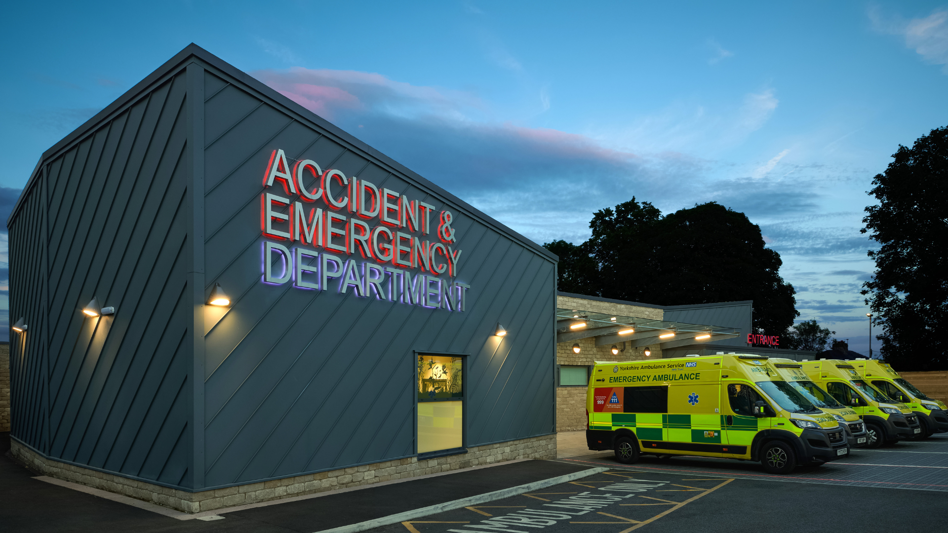A twilight photo of the outside of HRI Accident and Emergency Department