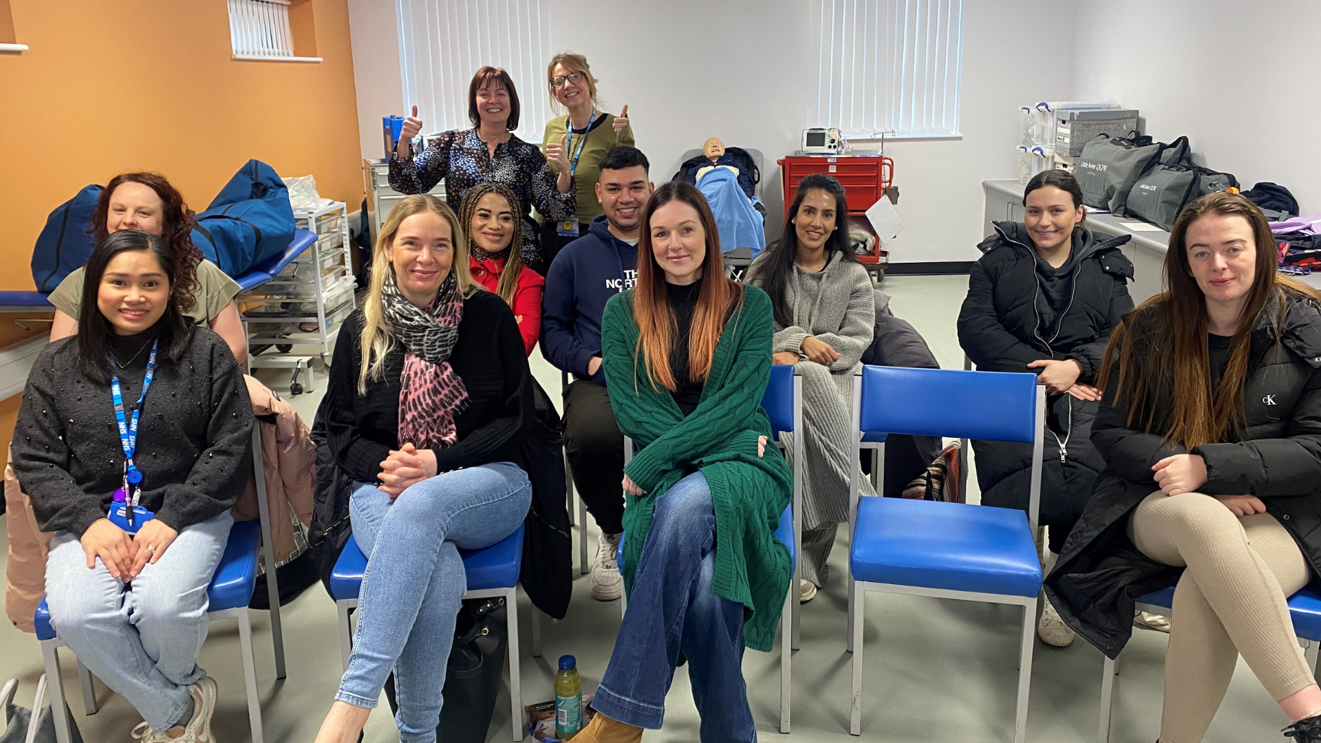 A photo of people at a training course smiling to camera 