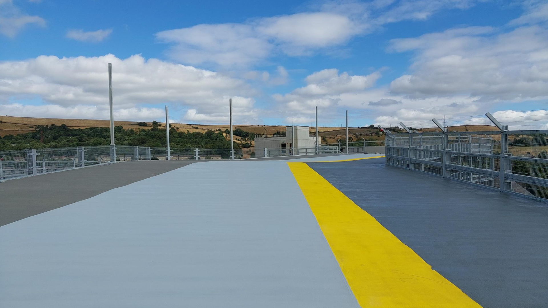 A photo of the top floor of the new multi-storey car park at CRH with the pedestrian walkway painted