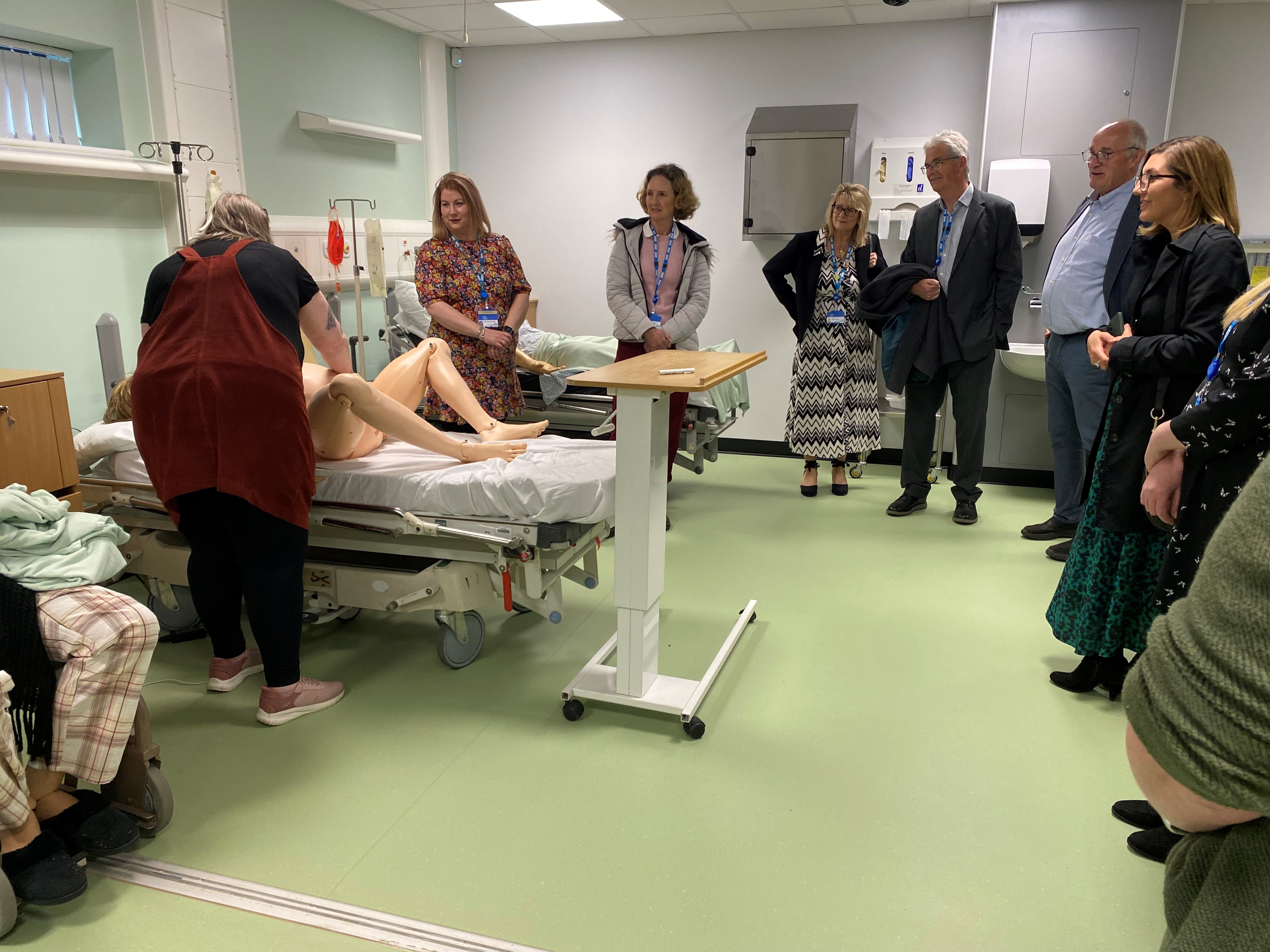 Visitors watching part of a mannikin simulated birth