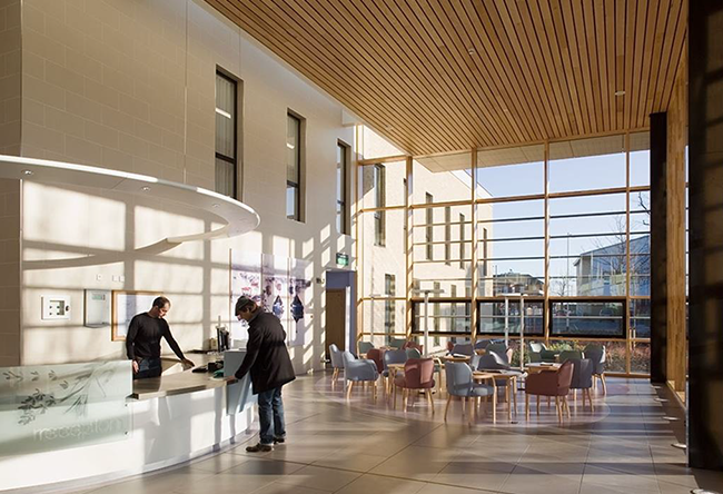 There is a well-lit waiting area with full-length windows that surround it.