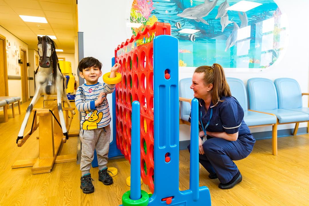 Nurse playing games with a child patient