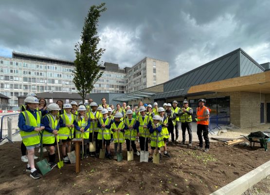 The children of Reinwood Juniors plant a tree outside the new A&E