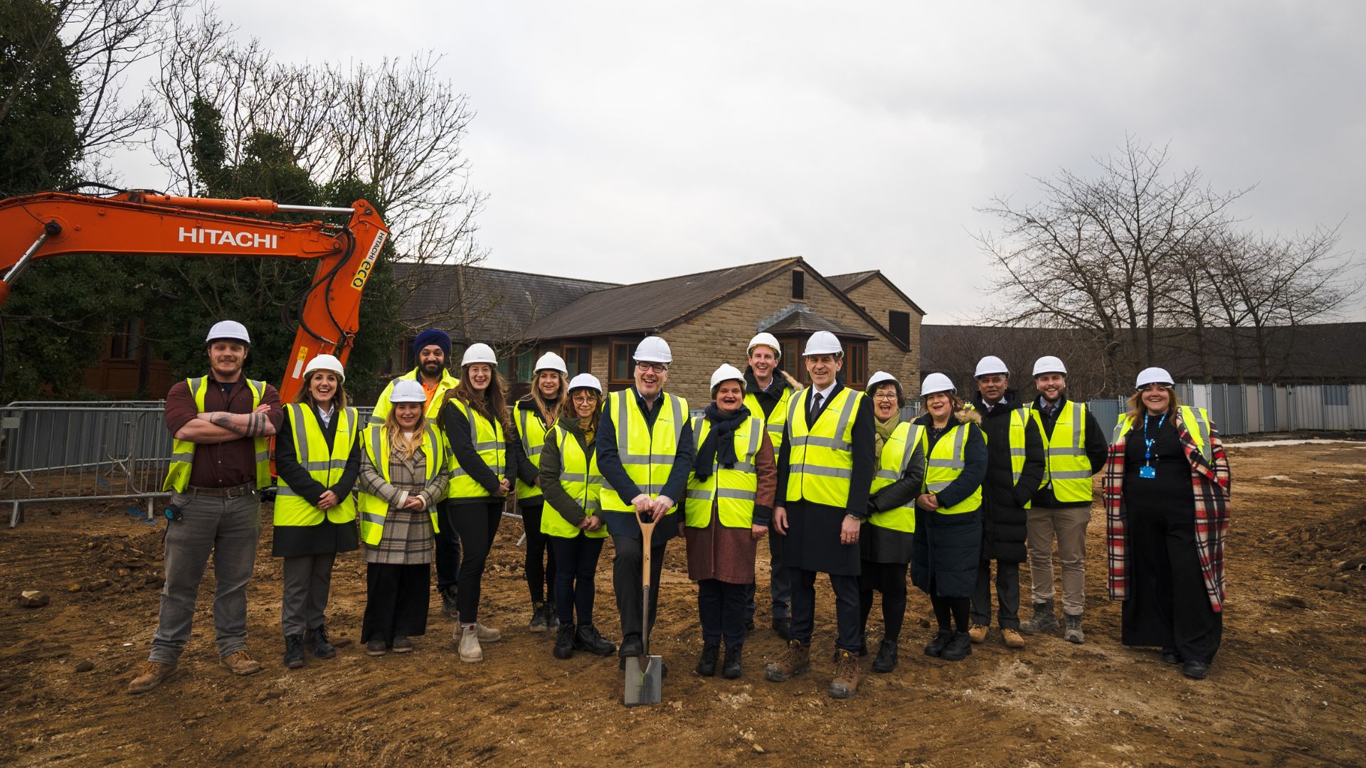 CHFT Chief Executive, Brendan Brown, stands centre with a ceremonial spade with colleagues from CHFT and partners at Darwin Group